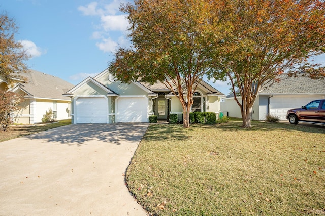 view of front of home featuring a front yard and a garage