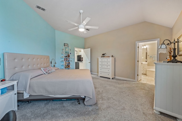 bedroom featuring ceiling fan, ensuite bath, lofted ceiling, and light carpet