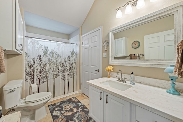 bathroom with vanity, vaulted ceiling, tile patterned floors, and toilet