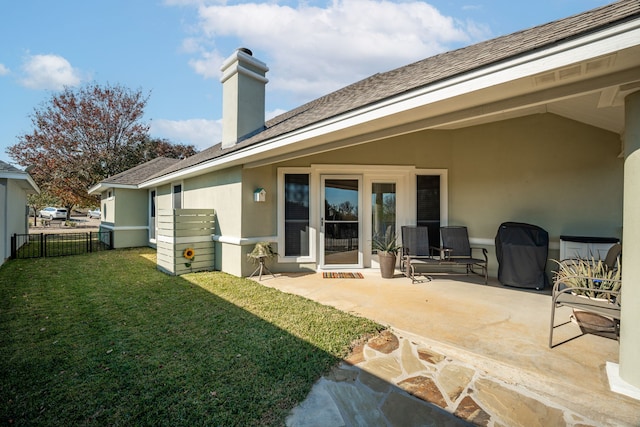 rear view of property with a yard and a patio area