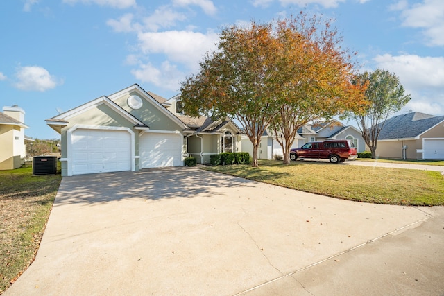 view of front of house featuring a garage, central AC, and a front lawn