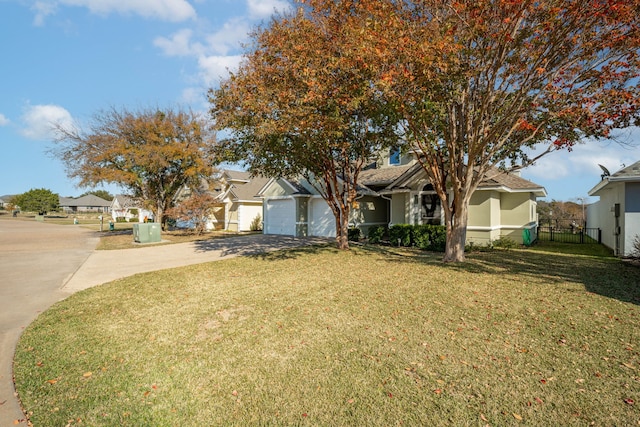 view of front of house featuring a garage and a front lawn