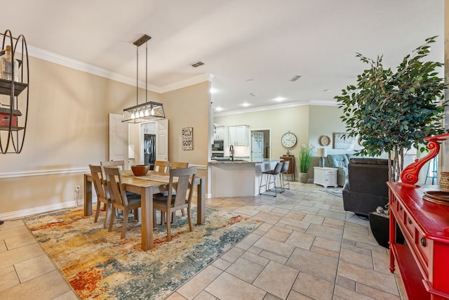 dining area featuring ornamental molding and sink