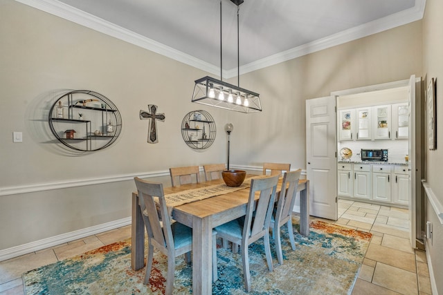 dining area with crown molding and light tile patterned flooring