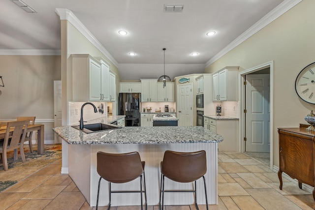 kitchen with pendant lighting, black appliances, sink, light stone counters, and kitchen peninsula