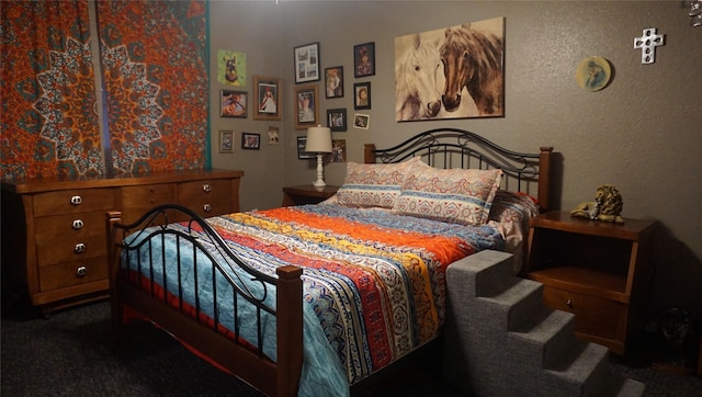 bedroom featuring dark colored carpet