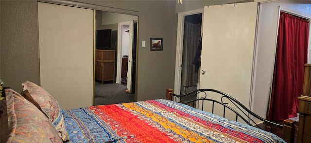 carpeted bedroom with a closet