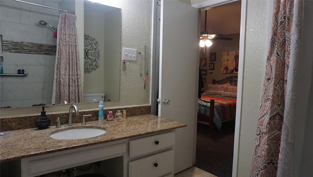 bathroom featuring ceiling fan, tile patterned flooring, vanity, and walk in shower