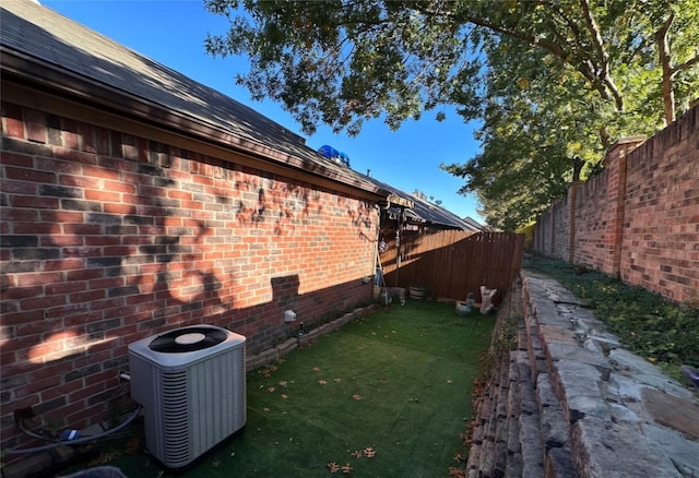 view of property exterior featuring a lawn and central air condition unit