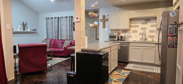 kitchen featuring backsplash, white cabinets, sink, and appliances with stainless steel finishes