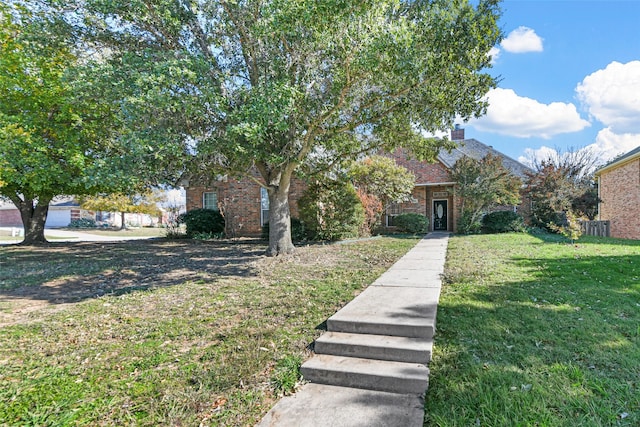 view of property hidden behind natural elements with a front lawn