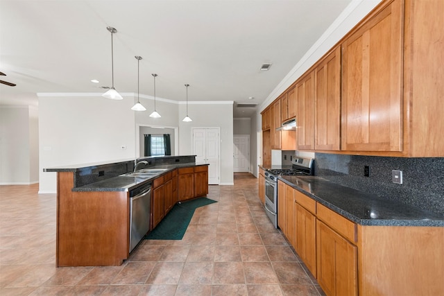 kitchen with stainless steel appliances, crown molding, sink, a large island with sink, and decorative light fixtures