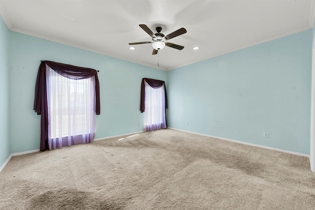 carpeted spare room featuring ceiling fan and ornamental molding