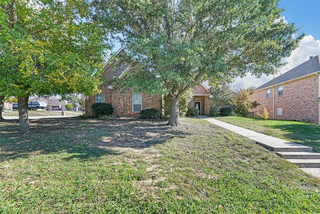 obstructed view of property with a front lawn