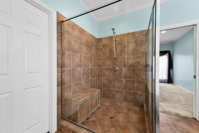 bathroom with tiled shower, tile patterned floors, and crown molding