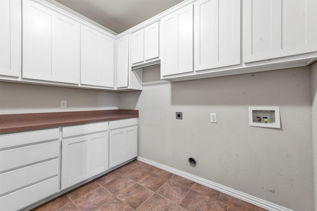 washroom with hookup for an electric dryer, cabinets, and washer hookup