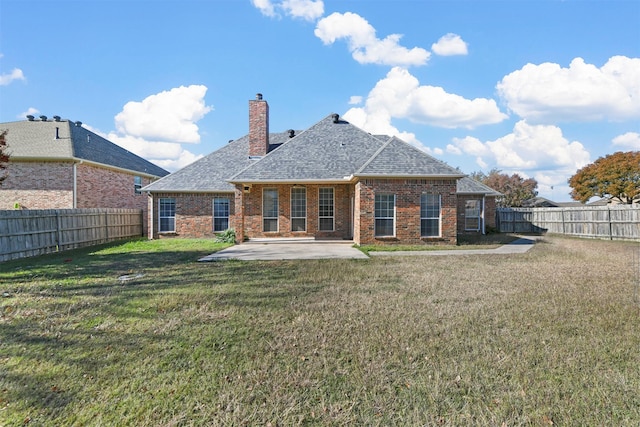 back of house featuring a yard and a patio