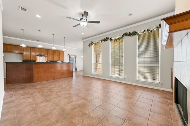 unfurnished living room featuring ceiling fan, ornamental molding, and light tile patterned floors