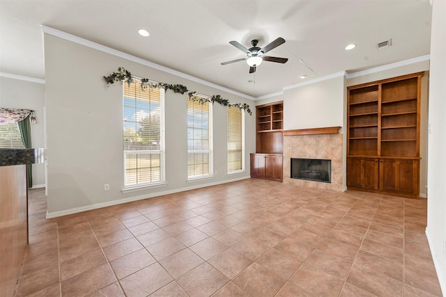 unfurnished living room with a fireplace, light tile patterned floors, ceiling fan, and crown molding