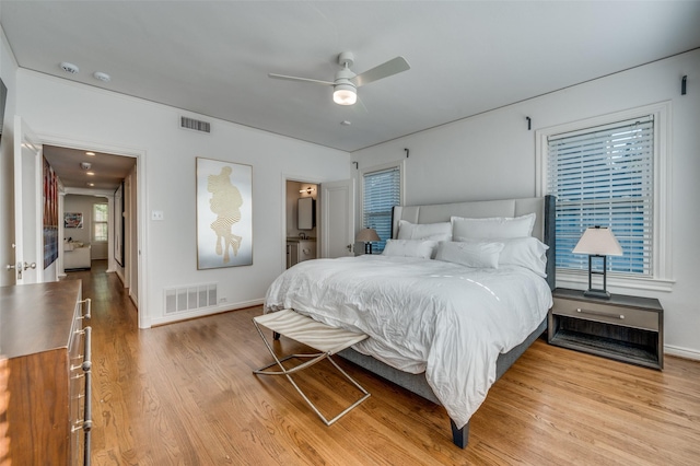 bedroom with light hardwood / wood-style floors and ceiling fan