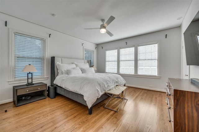 bedroom with light hardwood / wood-style flooring and ceiling fan