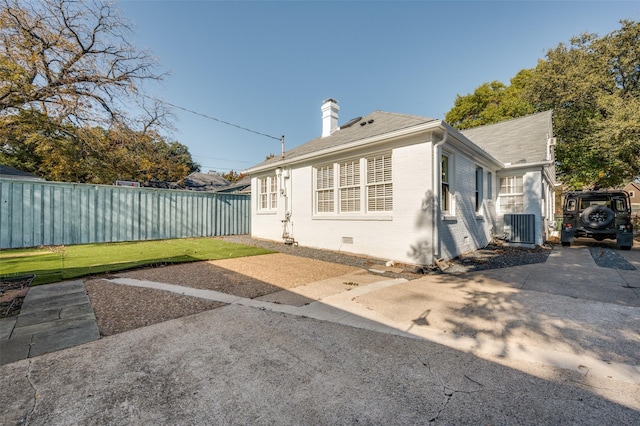 back of property with cooling unit and a patio area