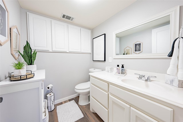 bathroom featuring hardwood / wood-style flooring, vanity, and toilet