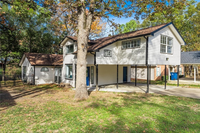 rear view of property with a lawn and a patio area