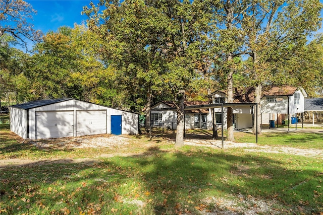 view of yard with a garage and an outdoor structure