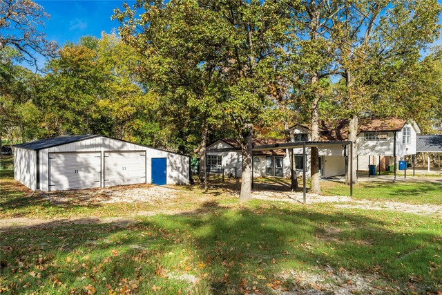 view of yard featuring an outbuilding and a garage