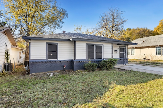 view of front of property with central AC unit and a front lawn