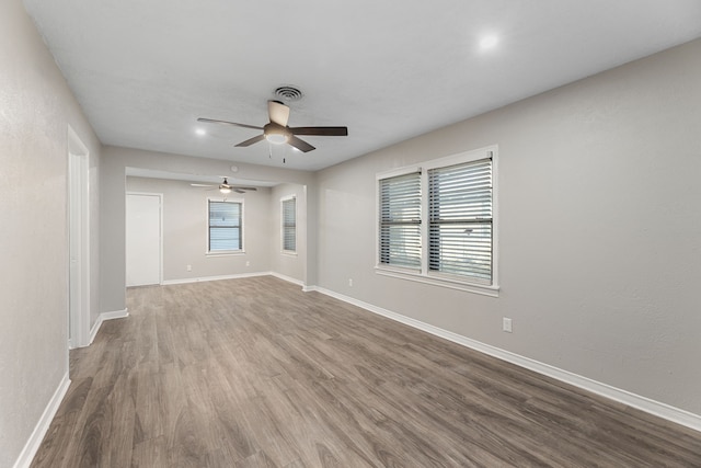 unfurnished room with hardwood / wood-style flooring and ceiling fan