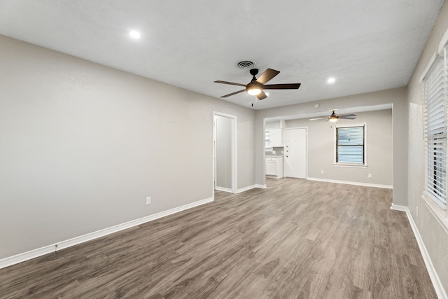 unfurnished living room with wood-type flooring