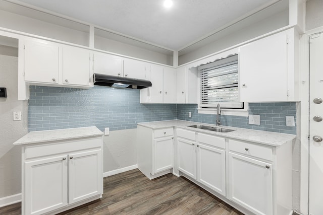 kitchen with decorative backsplash, white cabinetry, sink, and dark hardwood / wood-style floors