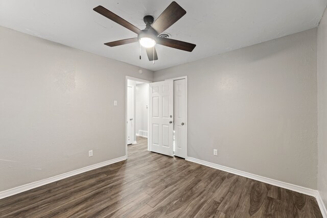 unfurnished bedroom featuring ceiling fan and dark wood-type flooring