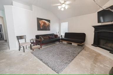 living room featuring ceiling fan and lofted ceiling