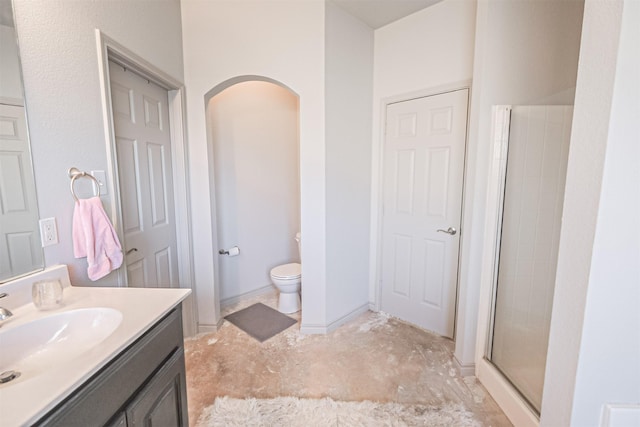 bathroom with vanity, toilet, and an enclosed shower