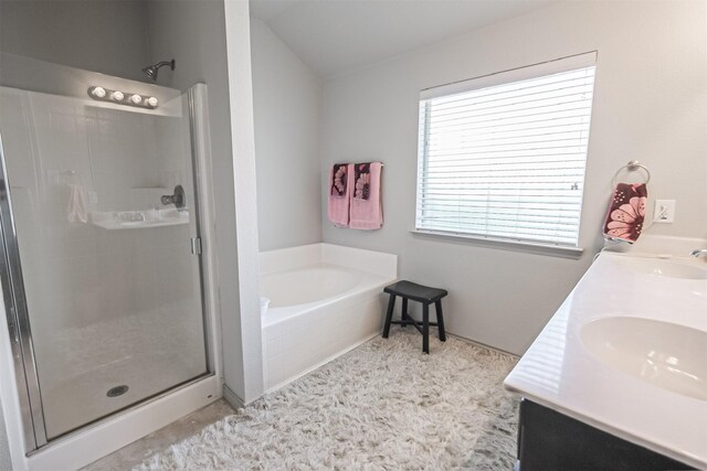 bathroom featuring vanity, lofted ceiling, and shower with separate bathtub