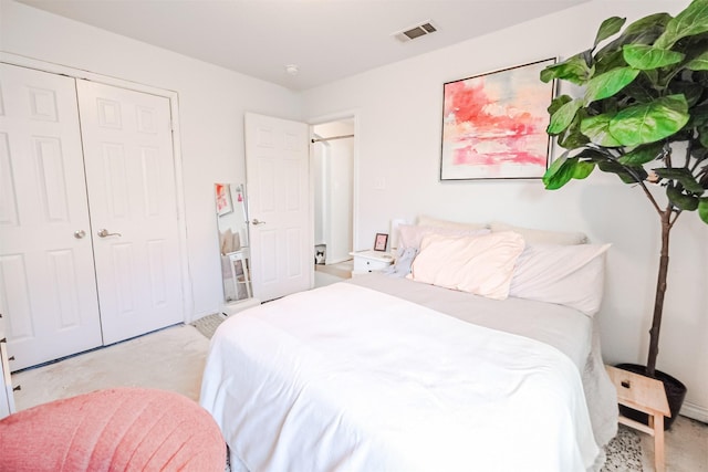 bedroom with light carpet and a closet