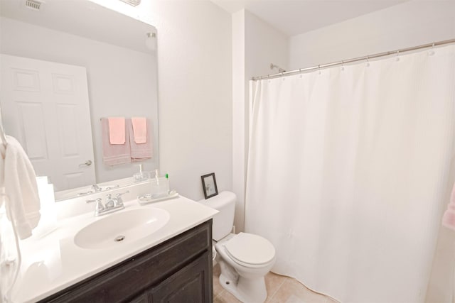 bathroom featuring tile patterned flooring, vanity, and toilet