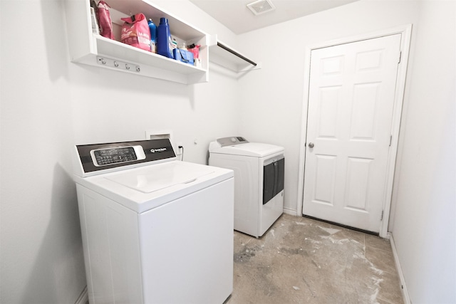 clothes washing area featuring separate washer and dryer