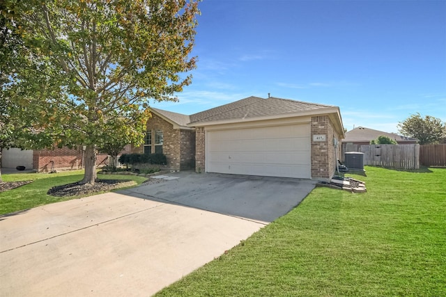 view of front of house featuring a garage, central AC, and a front yard