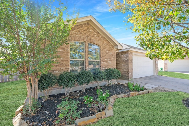 view of front facade featuring a garage and a front lawn