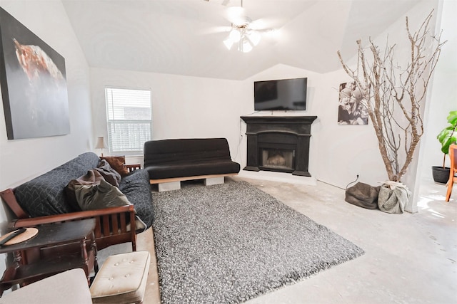 living room featuring ceiling fan, lofted ceiling, and concrete flooring