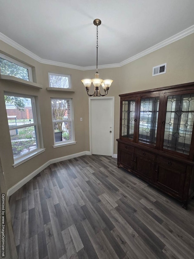 unfurnished dining area featuring a notable chandelier, crown molding, and dark wood-type flooring