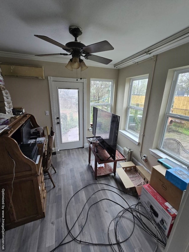 office area with a wall mounted air conditioner, hardwood / wood-style flooring, plenty of natural light, and ceiling fan