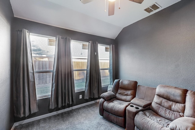 home theater room featuring carpet floors, vaulted ceiling, and ceiling fan