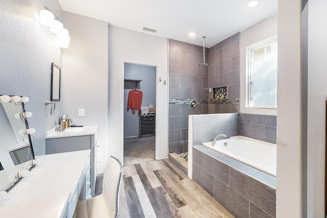 bathroom with shower with separate bathtub, vanity, and wood-type flooring