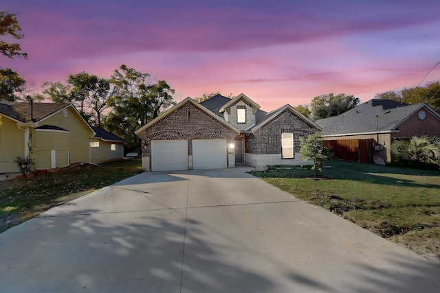 view of front of home with a lawn and a garage