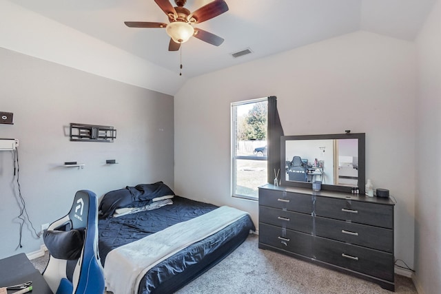 carpeted bedroom with ceiling fan and vaulted ceiling